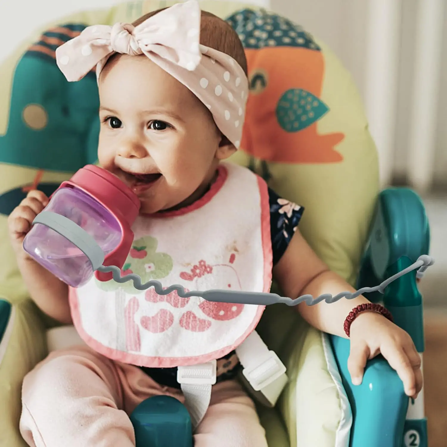 Five colorful, adjustable silicone toy straps for baby are displayed, demonstrating how they securely attach a teether, sippy cup, and other toys to a stroller, keeping them clean and off the ground.
