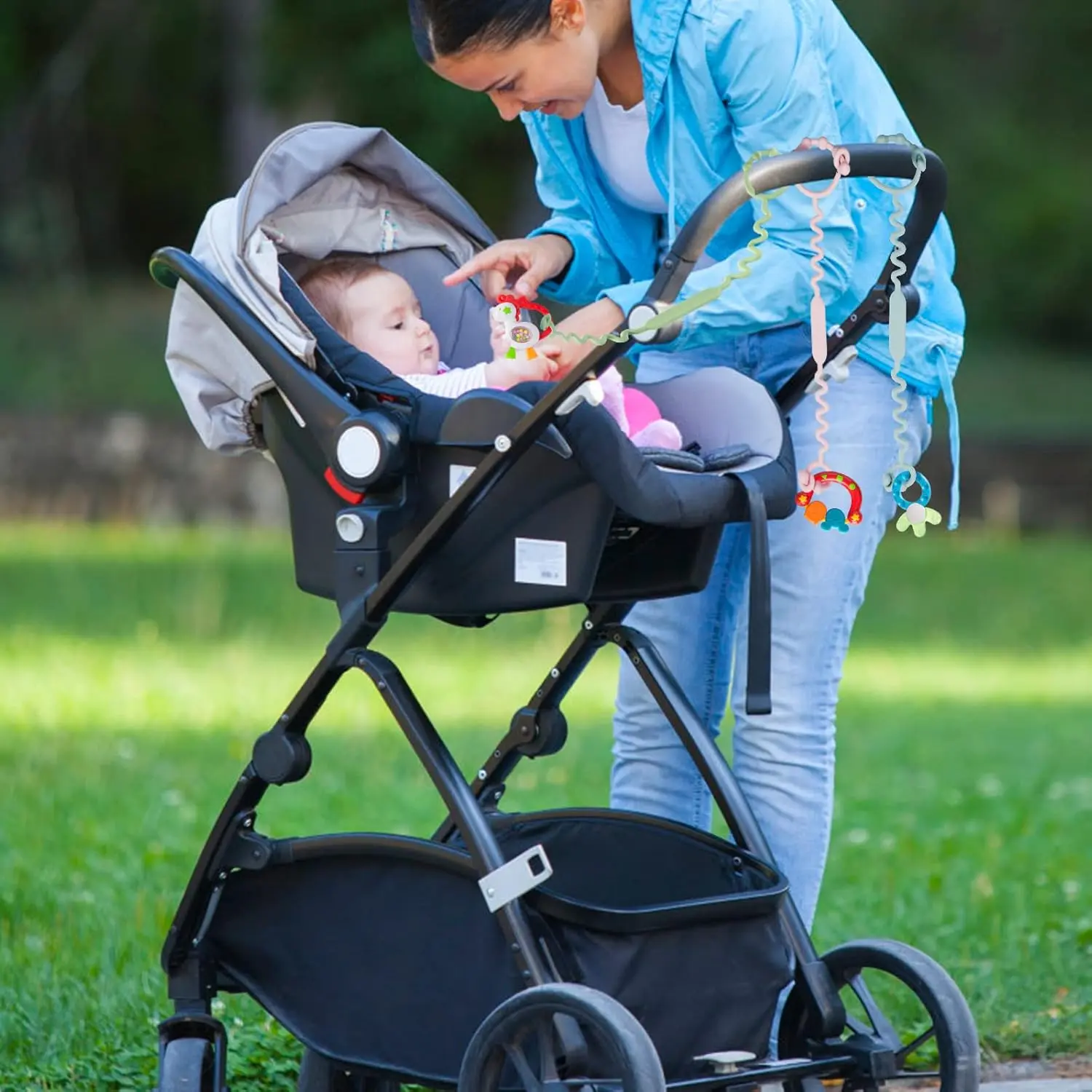 Five colorful, adjustable silicone toy straps for baby are displayed, demonstrating how they securely attach a teether, sippy cup, and other toys to a stroller, keeping them clean and off the ground.