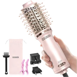 Pink 4-in-1 travel hair dryer brush with dual voltage for international use, featuring a round brush for straightening, curling, volumizing, and drying hair.