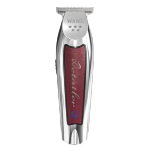Burgundy Wahl Detailer Li cordless trimmer featuring a T-blade for precise detailing and close trimming, displayed next to its charging stand.