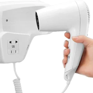 A white 1300W wall-mounted hair dryer with a concentrator nozzle and built-in power outlet is elegantly displayed, perfect for hotel bathrooms or home use.